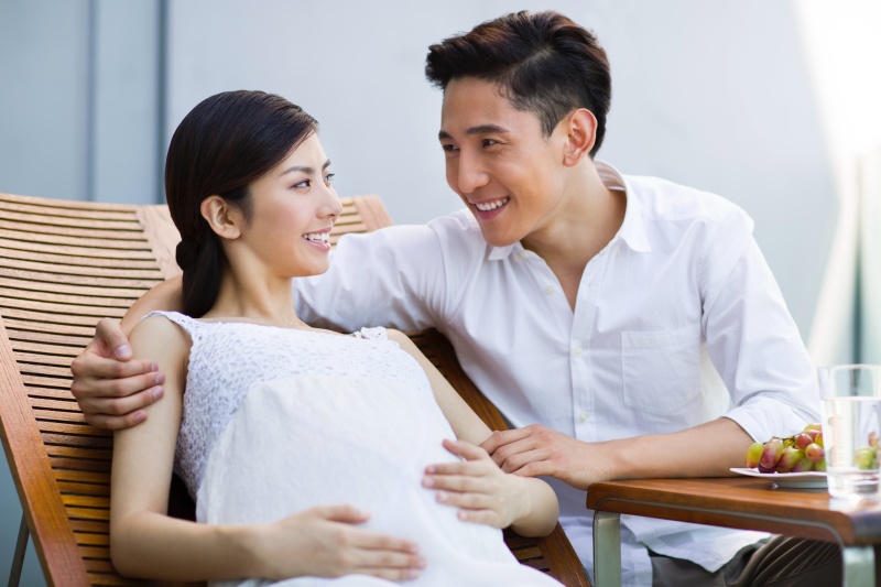 Happy pregnant Chinese woman and husband